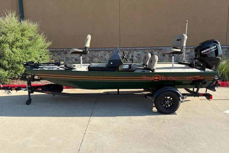 Slide: The Image of 2026 Tracker Bass Tracker Classic Limited boat on trailer, featuring Mercury outboard motor. - 2