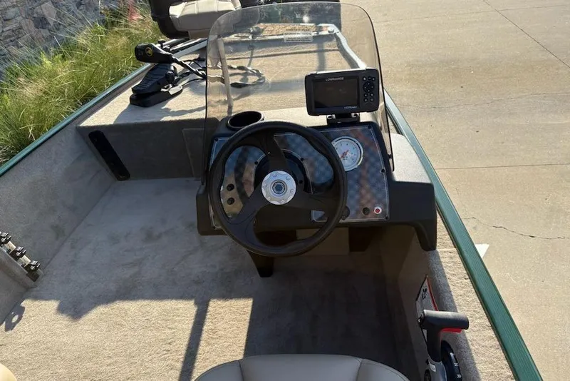 Slide: The Image of 2026 Tracker Bass Tracker Classic Limited boat cockpit with steering wheel and navigation system. - 3