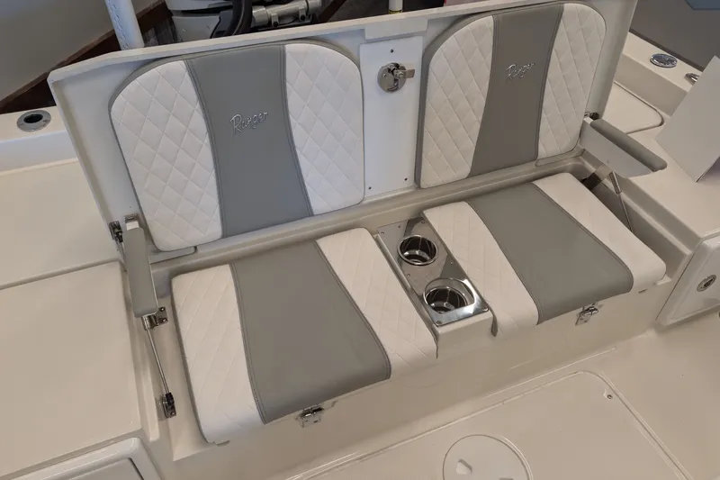 Slide: The Image of 2026 Ranger 2510 Bay boat seating with cup holders, featuring gray and white upholstery. - 9