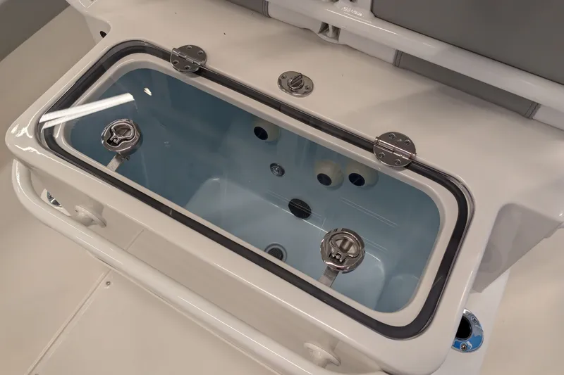 Slide: The Image of Livewell compartment on 2026 Ranger 2510 Bay boat, featuring secure latches and clear lid. - 10