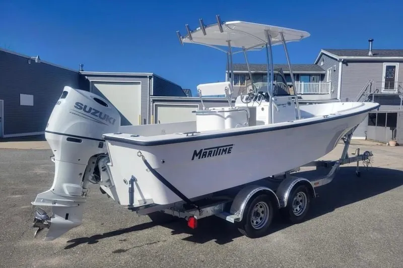 Slide: The Image of 2024 Maritime 233 Defiant boat on trailer with Suzuki outboard motor. - 3