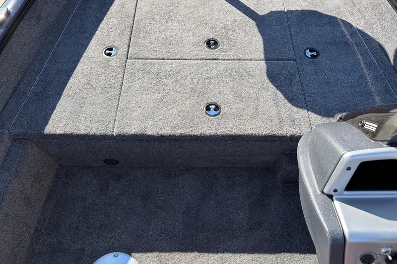 Slide: The Image of 2026 Tracker Pro Team 175 Crappie Edition boat interior with gray carpeted deck. - 19