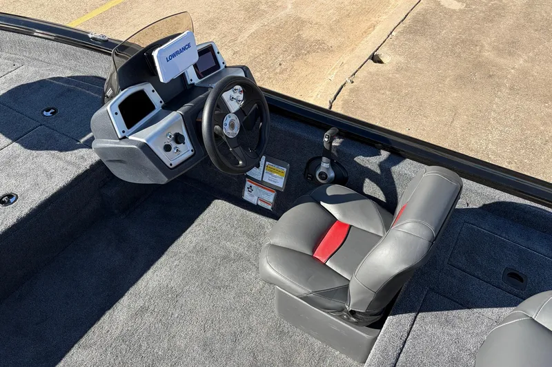 Slide: The Image of 2026 Tracker Pro Team 175 Crappie Edition boat interior with steering console and seat. - 23