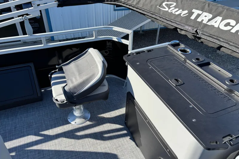 Slide: The Image of 2026 Sun Tracker SportFish 22 XP3 interior with seating and storage area. - 13