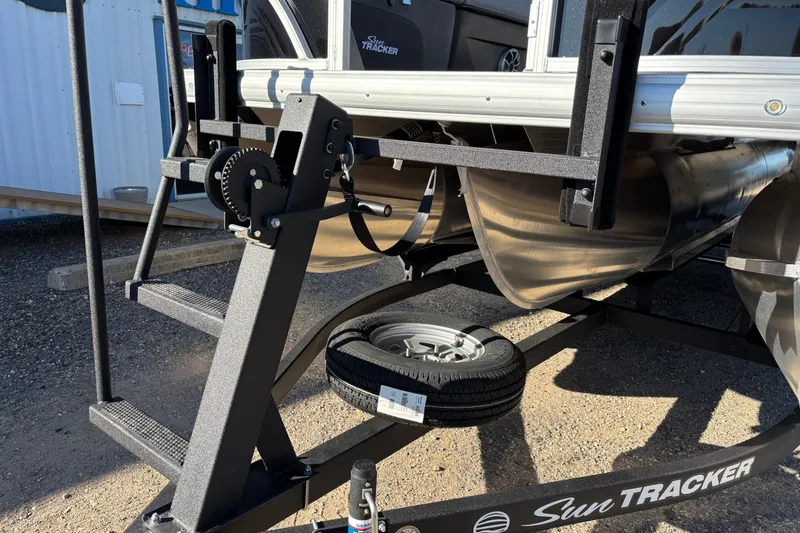 Slide: The Image of 2026 Sun Tracker SportFish 22 XP3 pontoon boat on trailer, close-up view. - 5