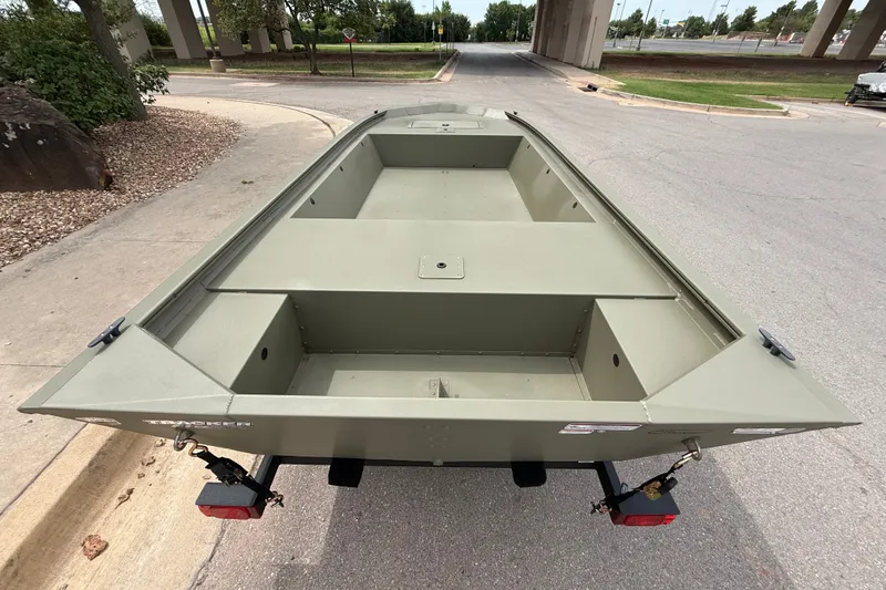 Slide: The Image of 2026 Tracker Grizzly 1648 Utility boat on trailer, parked outdoors. - 6