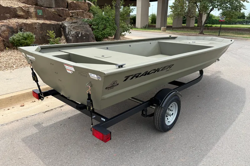 Slide: The Image of 2026 Tracker Grizzly 1648 Utility boat on trailer, parked outdoors. - 4