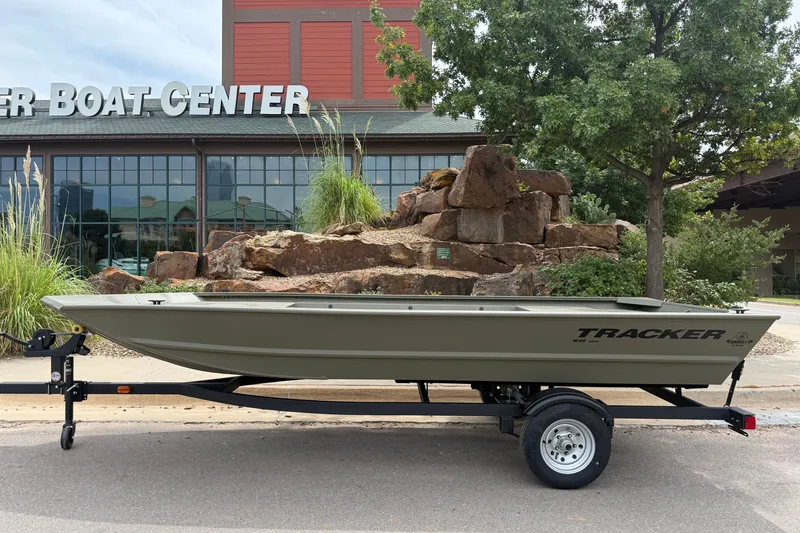 The Image of 2026 Tracker Grizzly 1648 Utility boat on trailer outside a boat center. - 0
