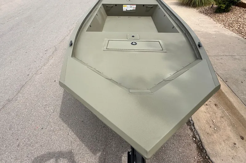 Slide: The Image of 2026 Tracker Grizzly 1648 Utility boat on pavement, showcasing its sturdy design. - 7