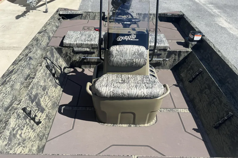 Slide: The Image of 2026 Tracker Grizzly 2072 CC boat interior with camouflage seating and console. - 10