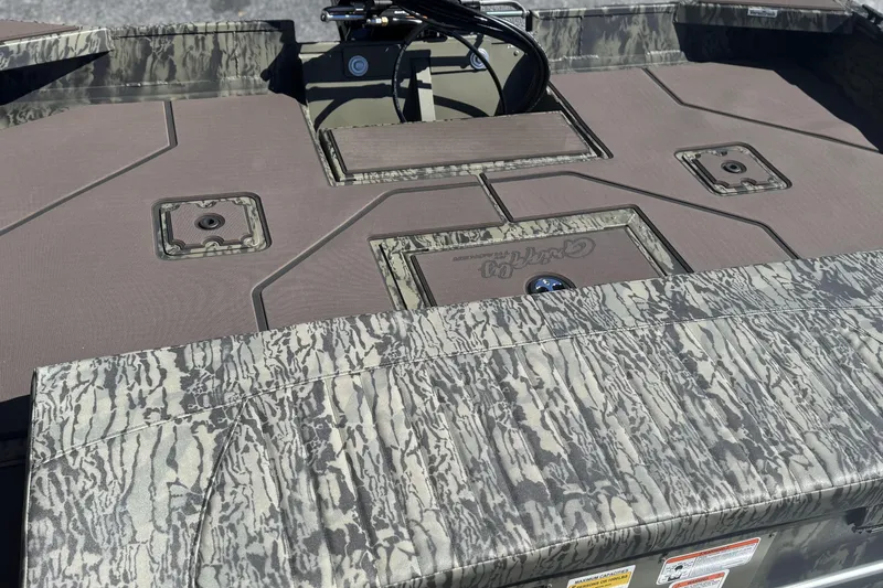 Slide: The Image of 2026 Tracker Grizzly 2072 CC boat deck with camouflage pattern and storage compartments. - 11