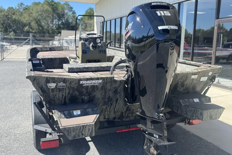 Slide: The Image of 2026 Tracker Grizzly 2072 CC boat with Mercury 115 engine, parked outdoors. - 3