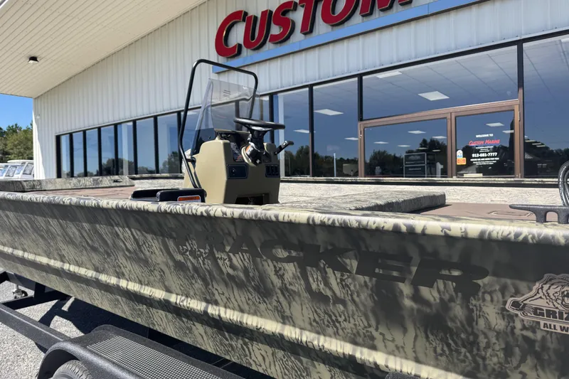 Slide: The Image of 2026 Tracker Grizzly 2072 CC boat outside Custom Marine store. - 4
