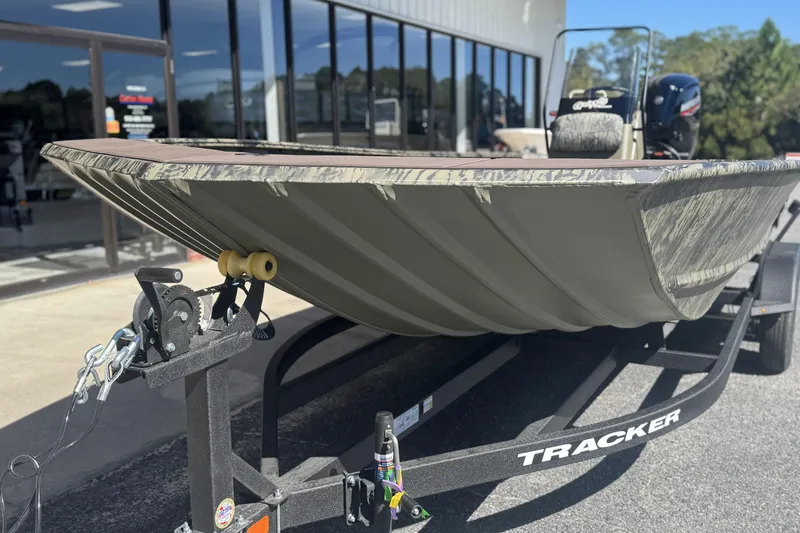 Slide: The Image of 2026 Tracker Grizzly 2072 CC boat on trailer outside dealership. - 6