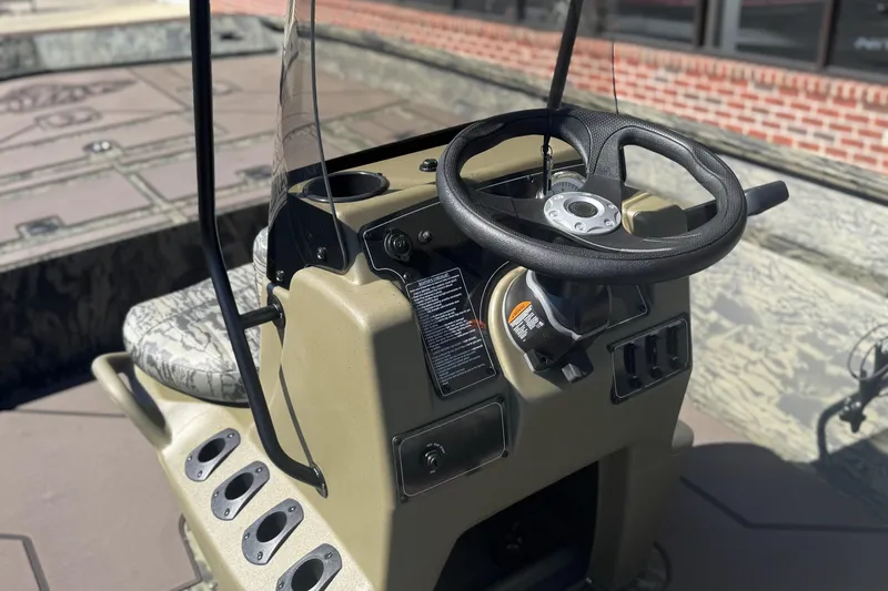 Slide: The Image of 2026 Tracker Grizzly 2072 CC boat console with steering wheel and controls. - 8