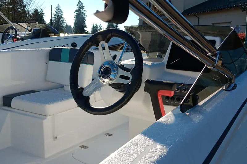 Slide: The Image of 2026 Tahoe T16 boat interior with steering wheel and seating, showcasing modern design. - 62