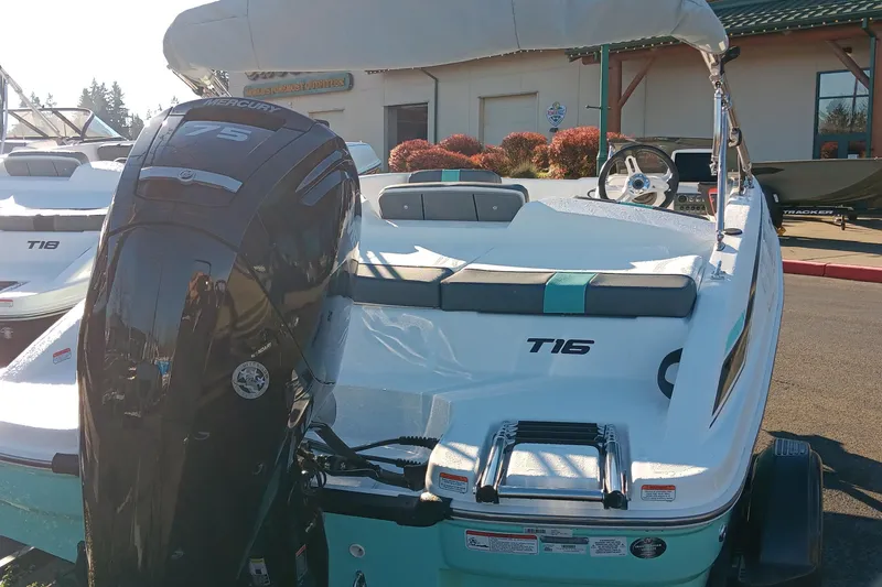 Slide: The Image of 2026 Tahoe T16 boat with Mercury engine, displayed outdoors in a sunny setting. - 63
