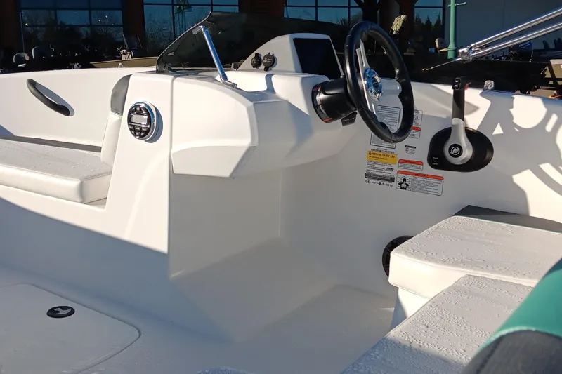 Slide: The Image of 2026 Tahoe T16 boat interior with steering wheel and seating, showcasing modern design. - 65