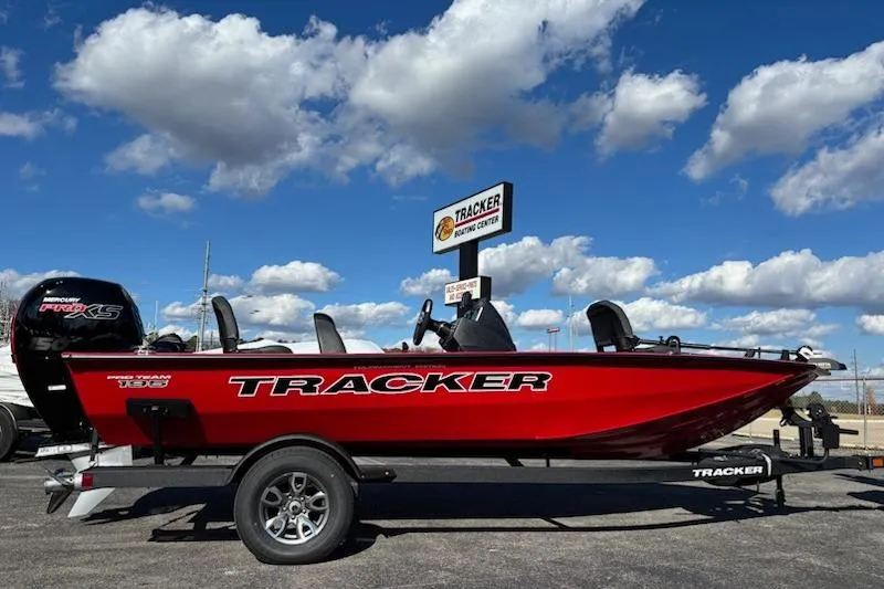The Image of 2026 Tracker Pro Team 195 boat in vibrant red, displayed outdoors under a blue sky. - 0