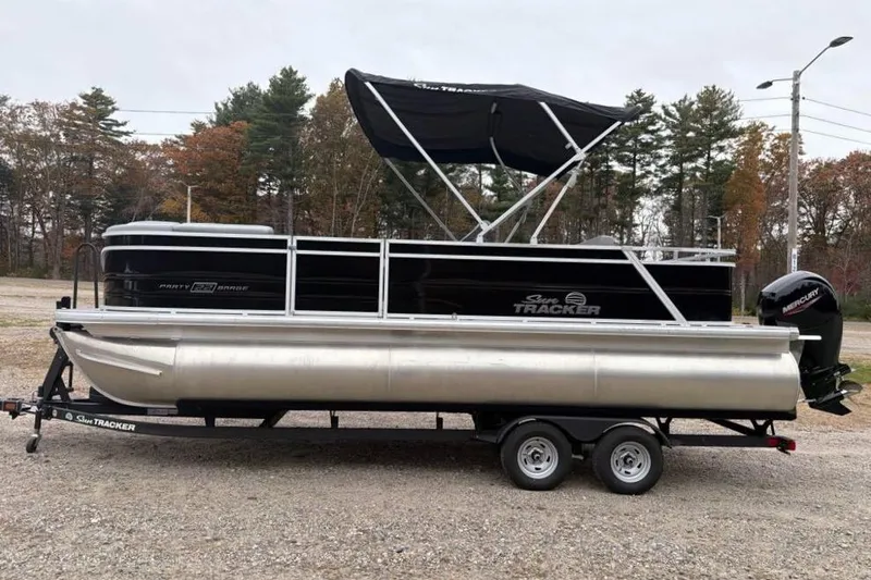 The Image of 2026 Sun Tracker Party Barge 22 RF XP3 pontoon boat on trailer, parked outdoors. - 0