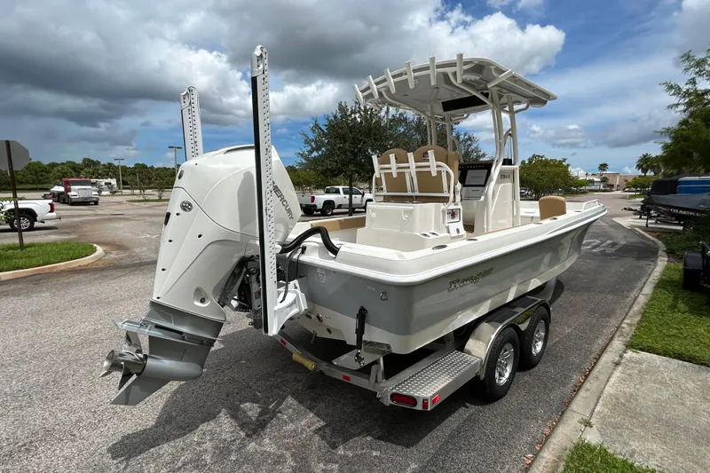 Slide: The Image of 2026 Ranger 2360 Bay boat on trailer, parked outdoors under cloudy sky. - 3