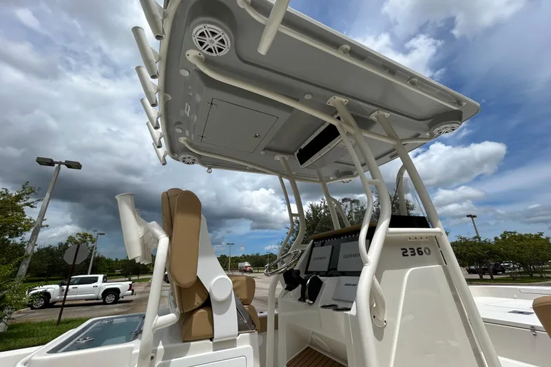 Slide: The Image of 2026 Ranger 2360 Bay boat console with T-top under cloudy sky. - 7