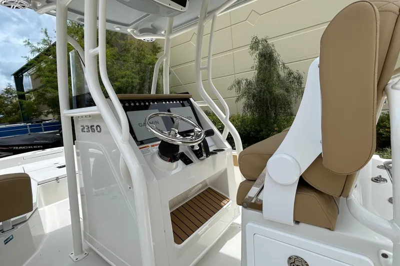 Slide: The Image of 2026 Ranger 2360 Bay boat console with Garmin display and tan seating. - 8