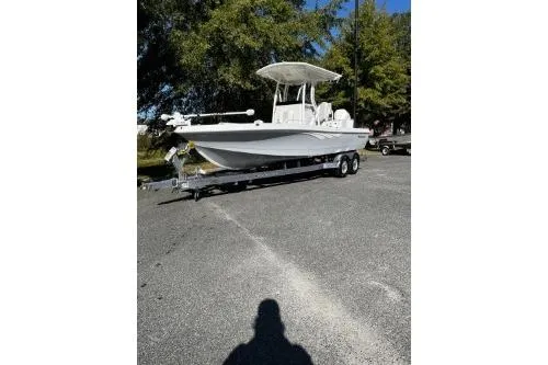 The Image of 2026 Ranger 2360 Bay boat on trailer, parked outdoors under trees. - 0