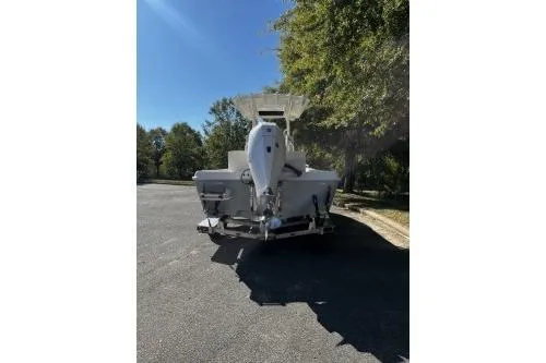 Slide: The Image of 2026 Ranger 2360 Bay boat on trailer, parked outdoors under clear sky. - 3