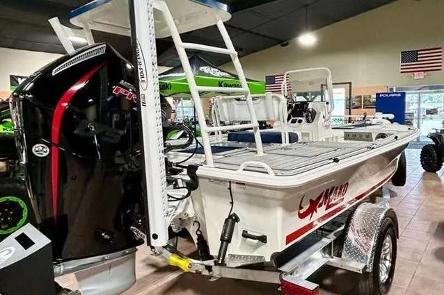 Slide: The Image of 2026 Mako 18 Pro Skiff Patriot Edition boat displayed indoors with powerful outboard motor. - 5