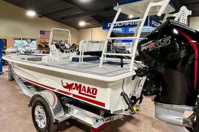 Slide: The Image of 2026 Mako 18 Pro Skiff Patriot Edition boat in showroom with Mercury Pro XS engine. - 7
