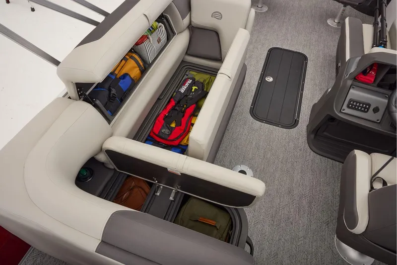 Slide: The Image of 2026 Sun Tracker Fishin' Barge 22 XP3 interior with storage compartment and seating. - 51