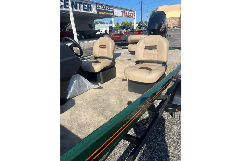 Slide: The Image of 2026 Tracker Bass Tracker Classic Limited boat with beige seats and steering console. - 2