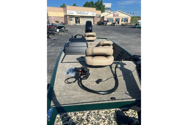 Slide: The Image of 2026 Tracker Bass Tracker Classic Limited boat with beige seats at a dealership. - 4