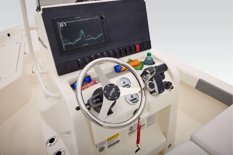 Slide: The Image of Helm of 2026 Mako 24 APEX boat with steering wheel and navigation display. - 35