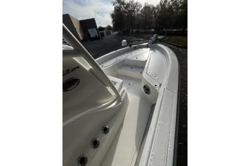 Slide: The Image of 2026 Mako 24 APEX boat, sleek white deck, outdoor setting. - 5