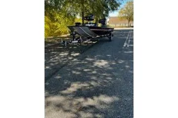 The Image of 2026 Tracker Bass Tracker Classic XL boat parked on a sunny road. - 0