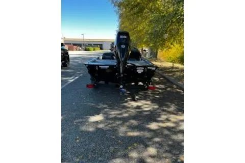 Slide: The Image of 2026 Tracker Bass Tracker Classic XL boat parked on a shaded street. - 3