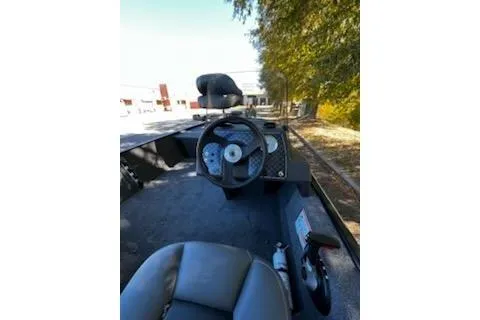 Slide: The Image of 2026 Tracker Bass Tracker Classic XL boat interior with steering wheel and seating. - 5