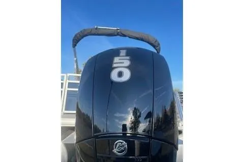 Slide: The Image of 2026 Sun Tracker SportFish 22 XP3 boat engine with 150 horsepower, under clear blue sky. - 3