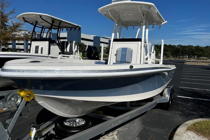 The Image of 2026 Ranger 2360 Bay boat on trailer in parking lot, sunny day. - 0