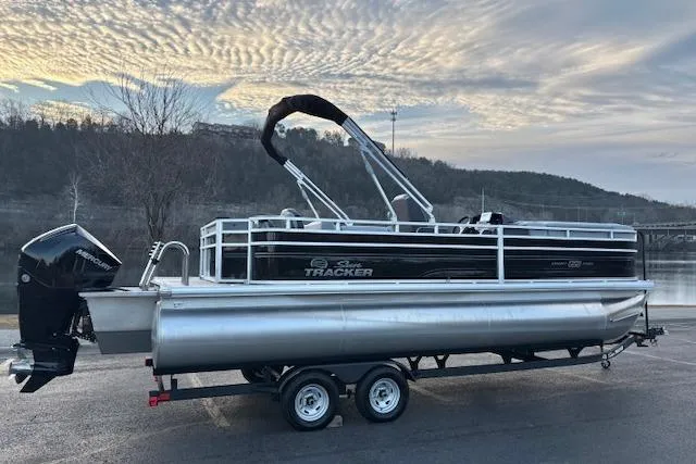 Slide: The Image of 2026 Sun Tracker SportFish 22 XP3 pontoon boat on trailer, scenic background. - 3