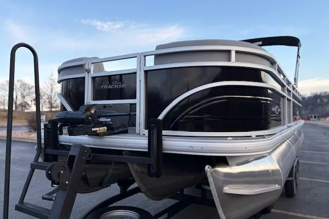 Slide: The Image of 2026 Sun Tracker SportFish 22 XP3 pontoon boat on trailer, sleek black design. - 9