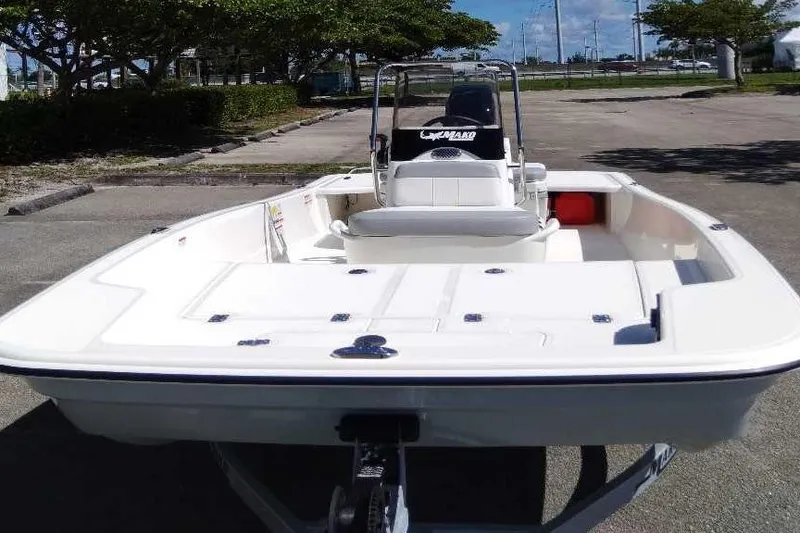 Slide: The Image of 2026 Mako Pro Skiff 15 CC boat on trailer, parked outdoors. - 2