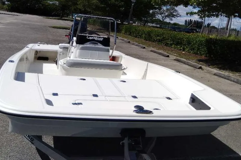 Slide: The Image of 2026 Mako Pro Skiff 15 CC boat parked on pavement under clear sky. - 3