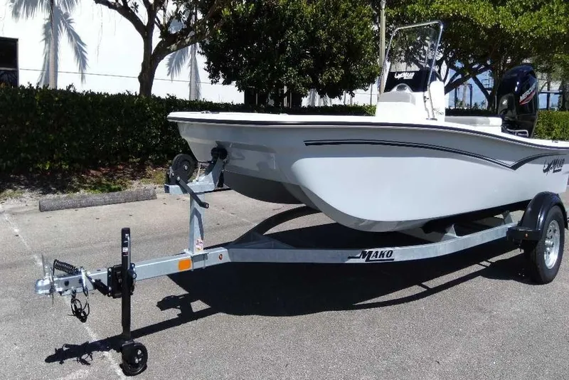 Slide: The Image of 2026 Mako Pro Skiff 15 CC boat parked outdoors on a sunny day. - 4