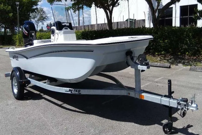 Slide: The Image of 2026 Mako Pro Skiff 15 CC boat on trailer, parked outdoors. - 5