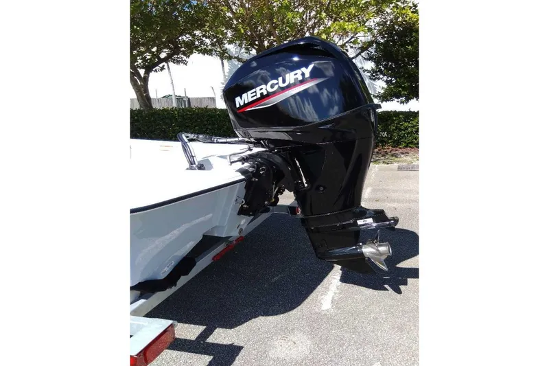 Slide: The Image of 2026 Mako Pro Skiff 15 CC boat with Mercury engine, parked outdoors. - 8
