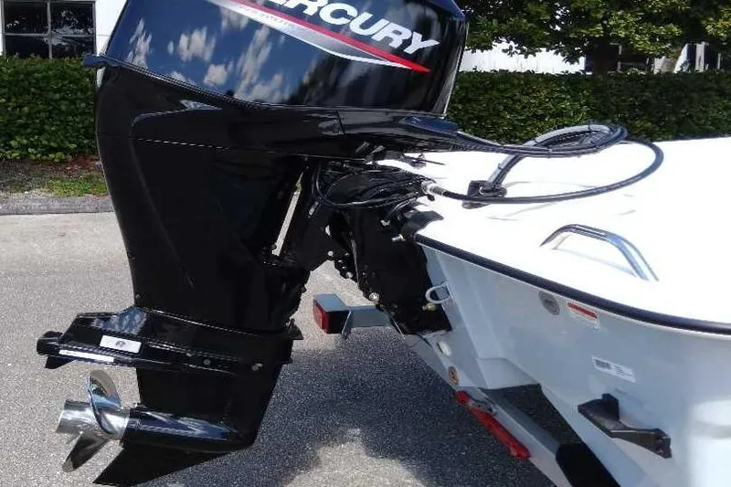 Slide: The Image of 2026 Mako Pro Skiff 15 CC with Mercury outboard motor in a parking lot. - 9