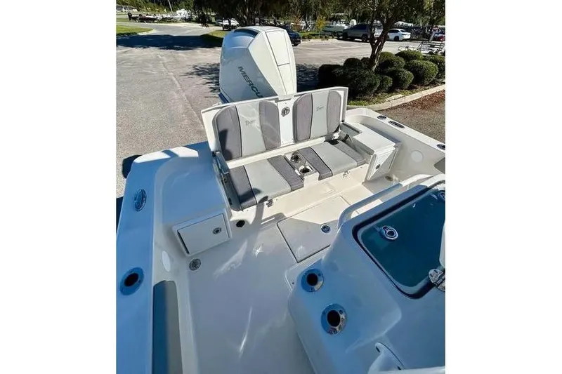 Slide: The Image of 2026 Ranger 2360 Bay boat interior with seating and Mercury engine. - 14